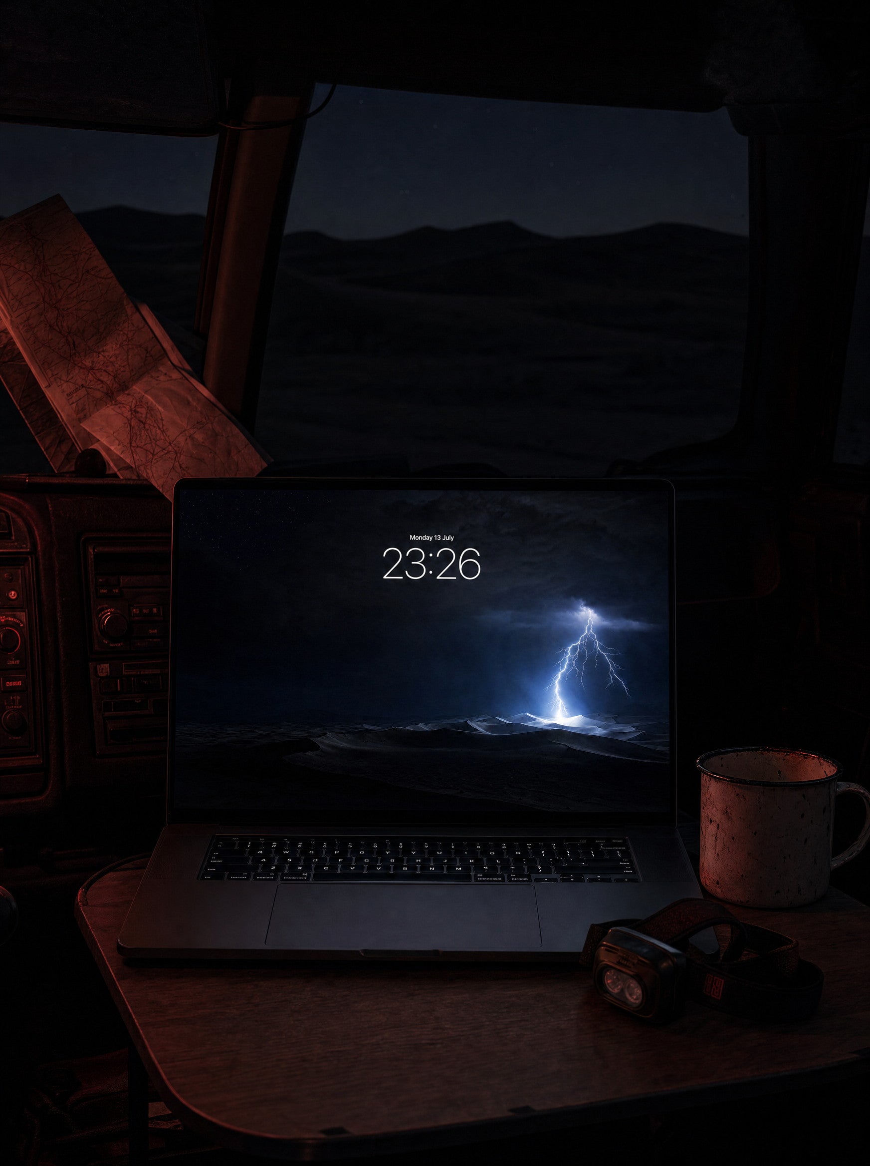 Desert Static wallpaper on a MacBook Pro, overland truck cab at night in the desert