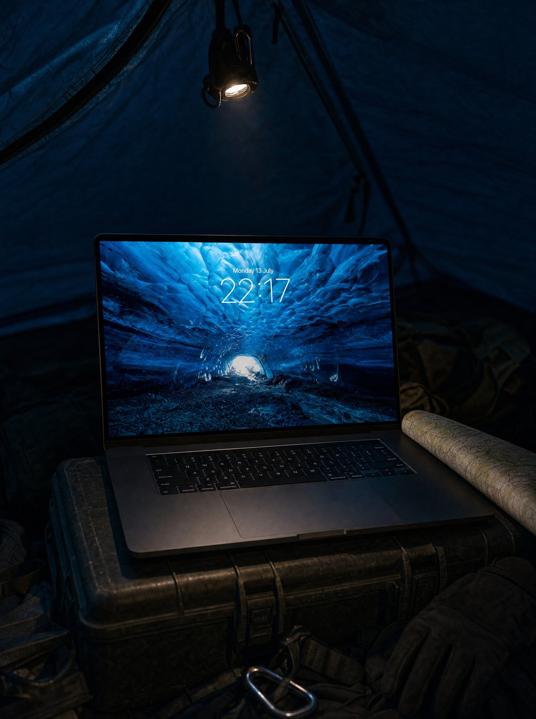 The Blue Cave wallpaper on a MacBook Pro inside an expedition tent at night