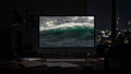 Sea State wallpaper on a large display in a dark studio office at night