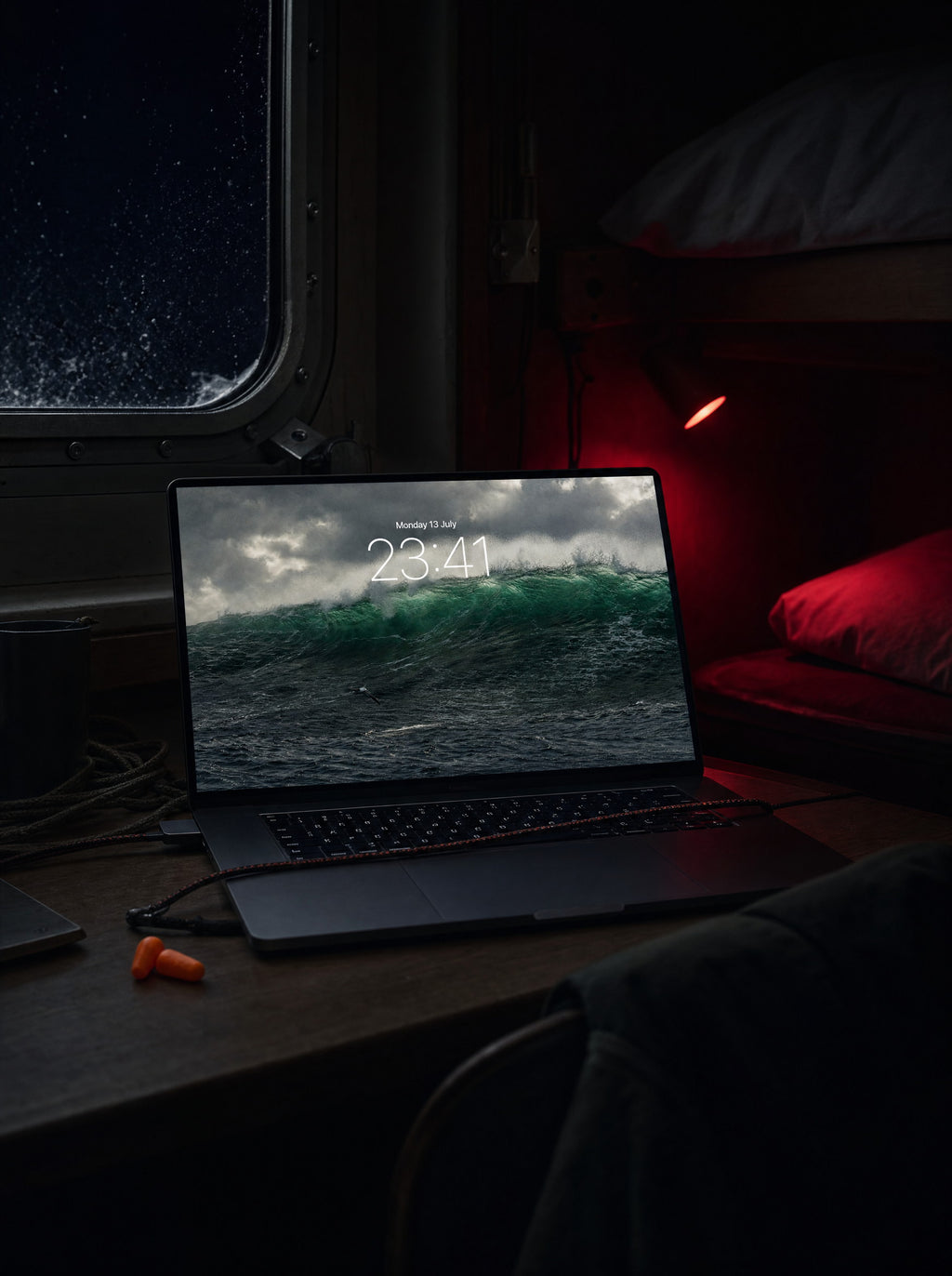 Sea State wallpaper on a MacBook Pro, ferry cabin at night mid-crossing
