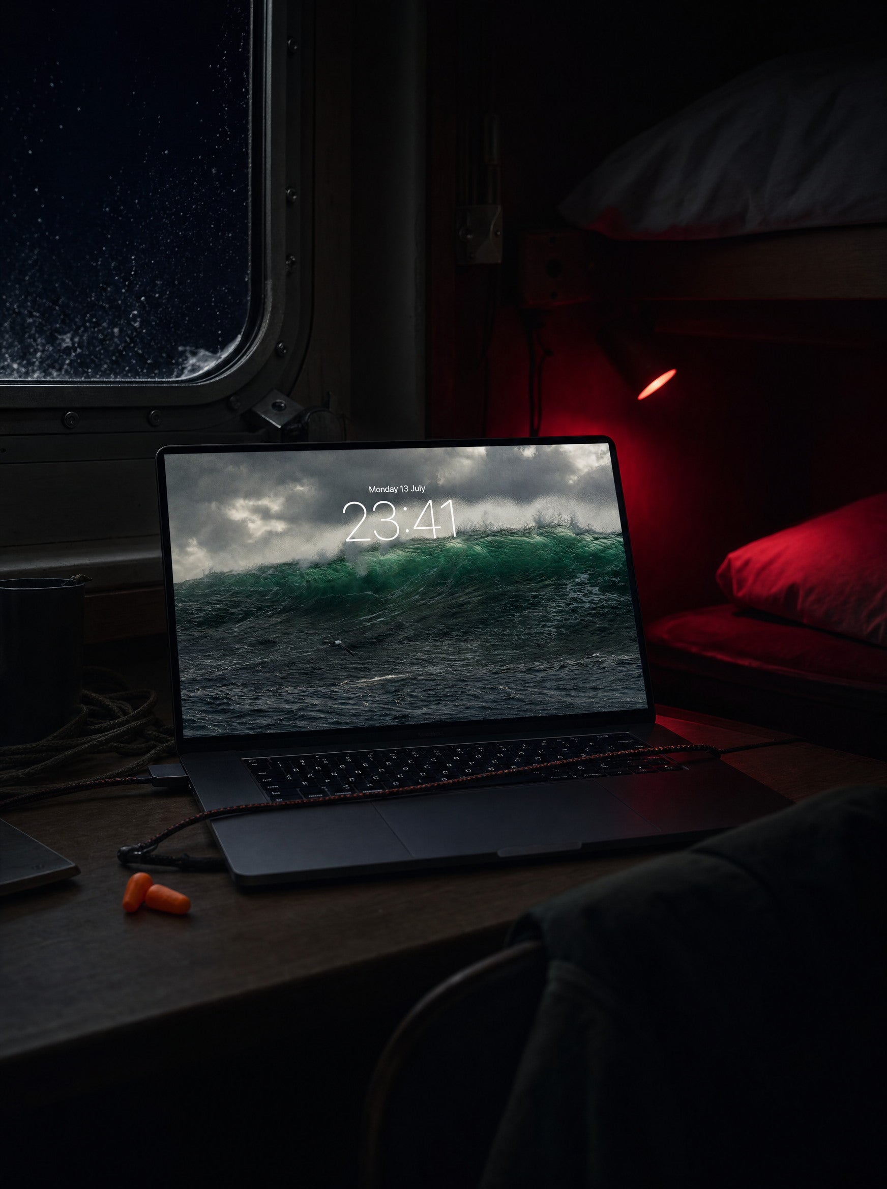 Sea State wallpaper on a MacBook Pro, ferry cabin at night mid-crossing