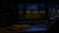 The Lantern Grove wallpaper on a 27-inch display in a dark studio office at night