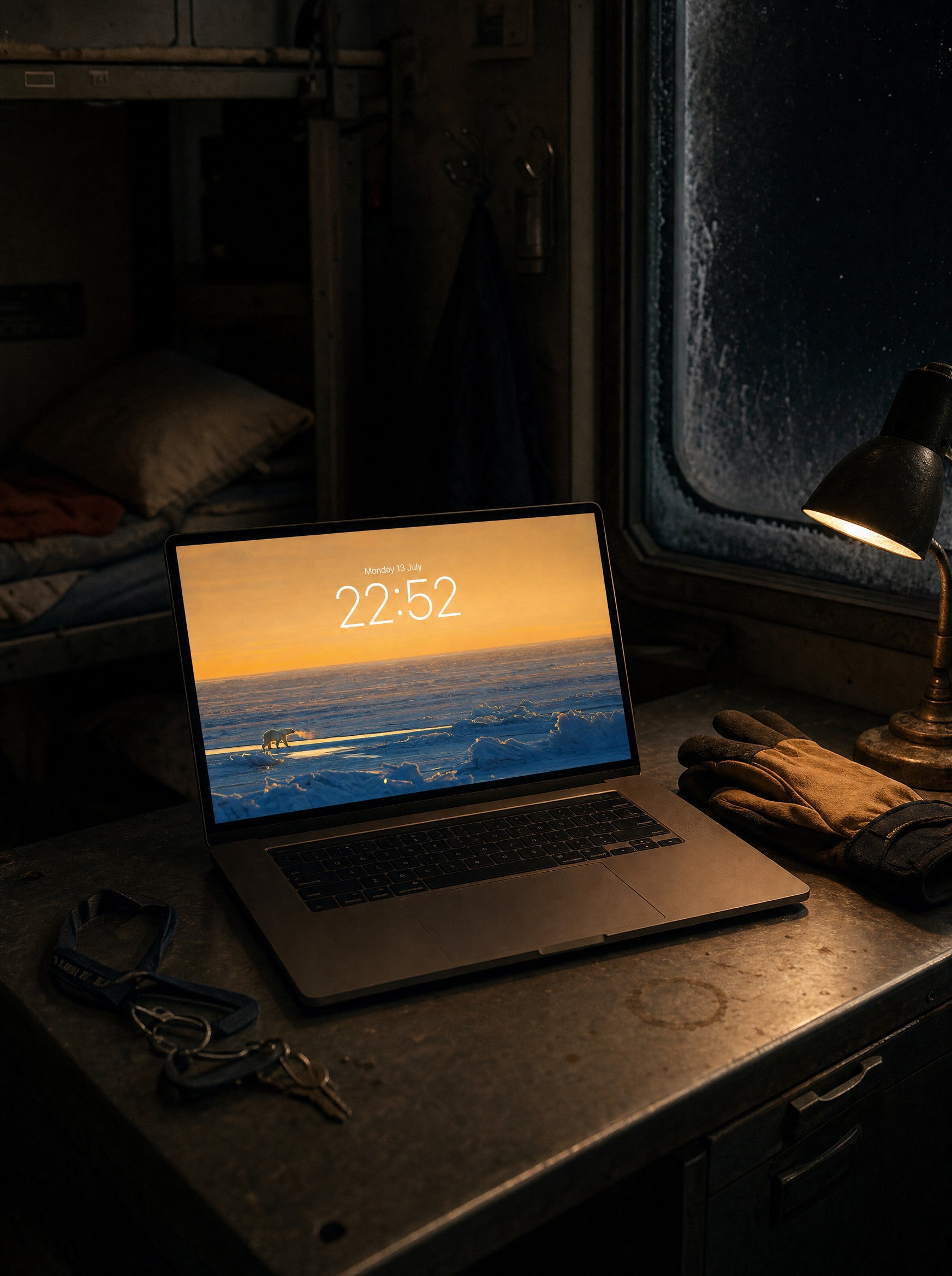 The Last Light wallpaper on a MacBook Pro in a research-station bunkroom at night