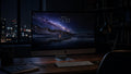 Starfall wallpaper on a 27-inch display in a darkened studio office at night