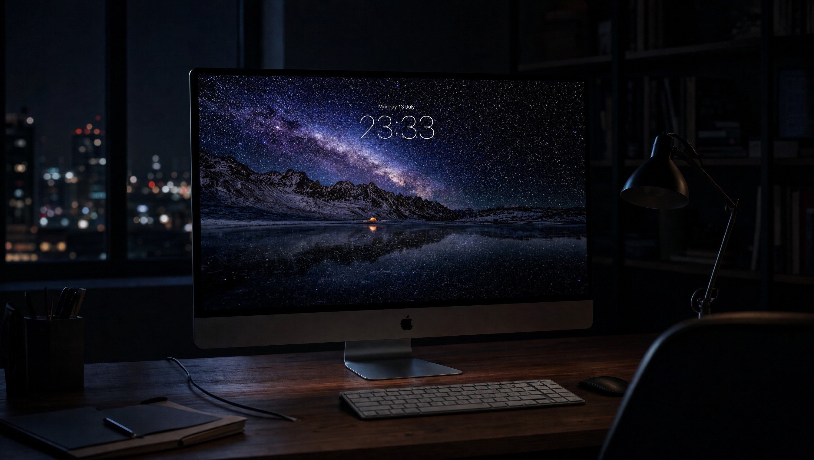 Starfall wallpaper on a 27-inch display in a darkened studio office at night