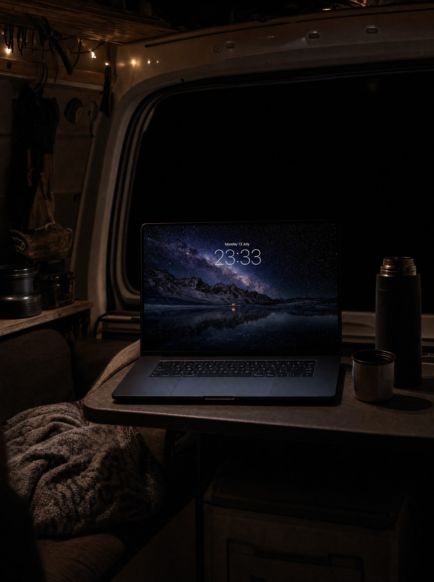 Starfall wallpaper on a MacBook Pro in a camper van parked in darkness