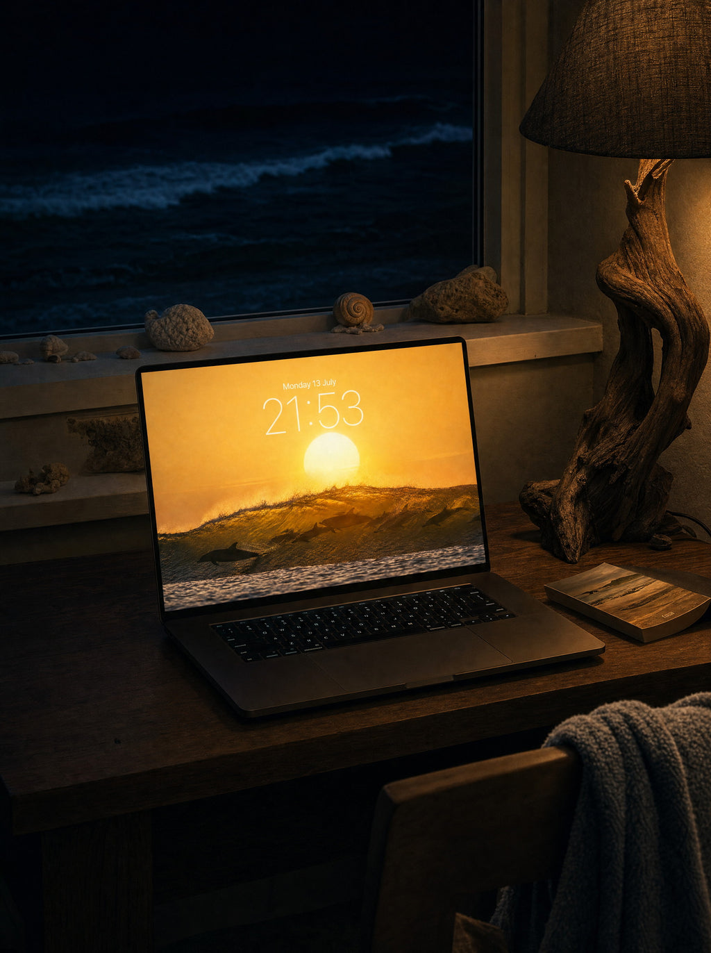 Last Swim wallpaper on a MacBook Pro at a beach-house desk at night